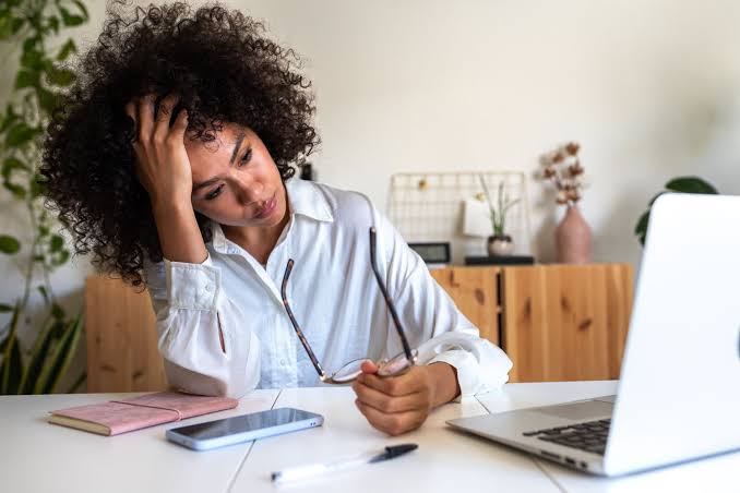 Woman exhausted at her desk — why high achievers burn out even when they love their work